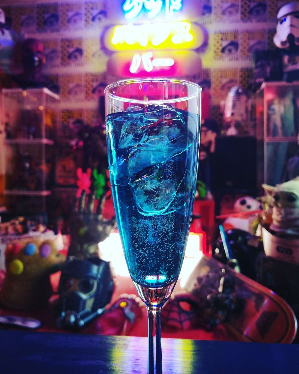 Vivid blue cocktail at a neon-lit Tokyo bar