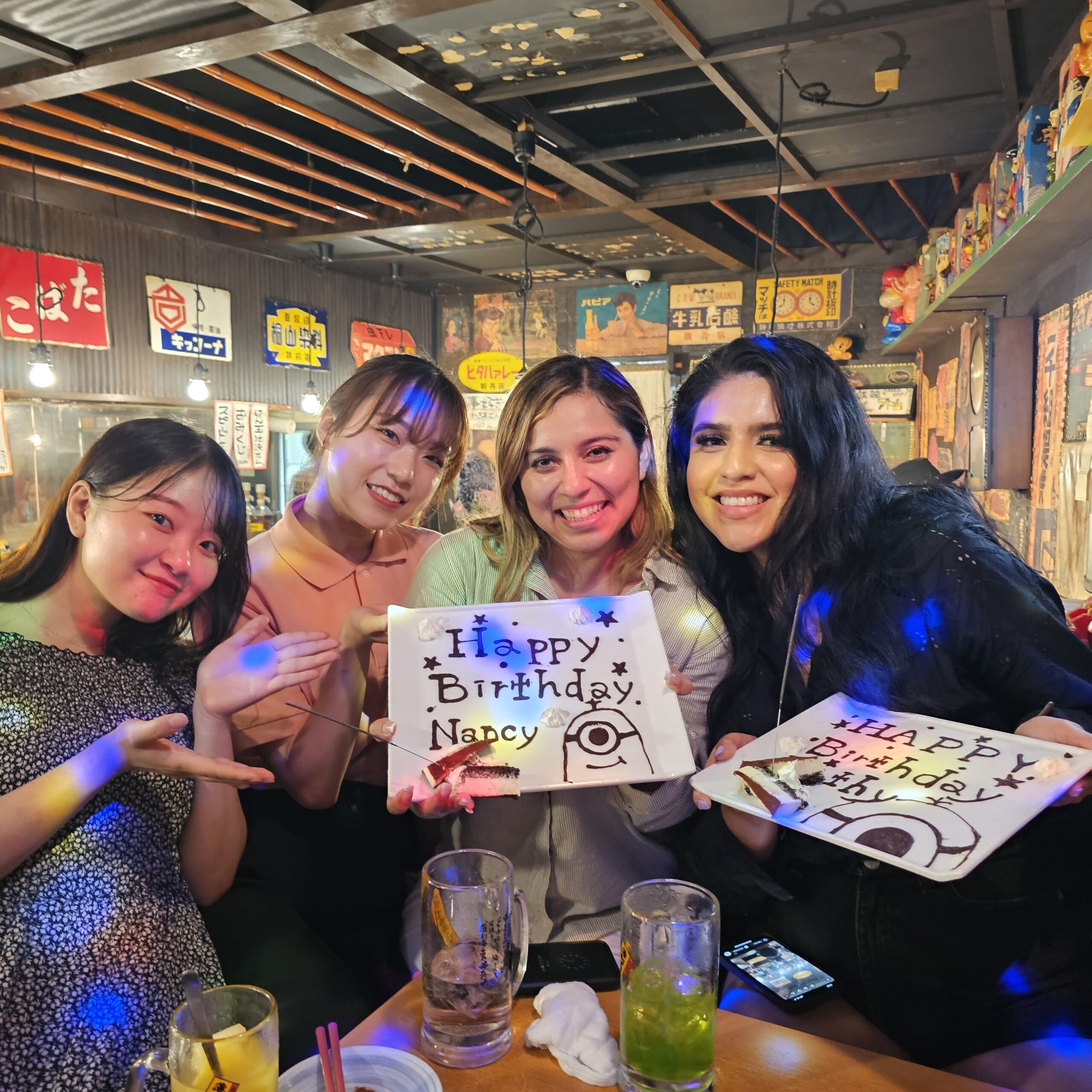 Friends celebrating a birthday inside a Tokyo restaurant
